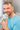 man holding CPAP mask and smiling indoors