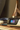 CPAP machine on a bedside table next to a smartphone and a modern lamp, highlighting sleep apnea therapy setup.